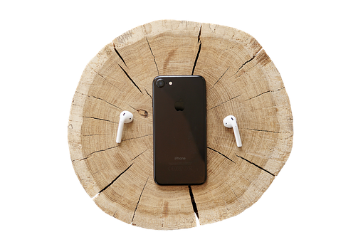 A Phone And Earbuds On A Tree Stump