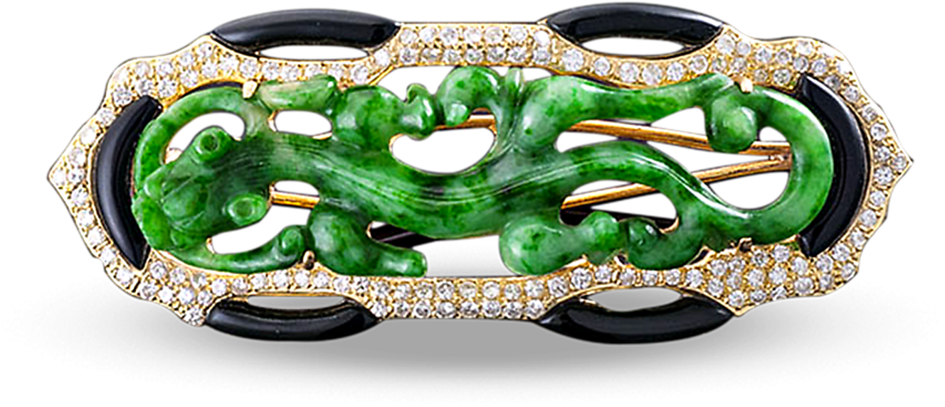 A Brooch With A Green And Black Design