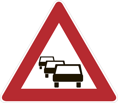 A Red Triangle Sign With Black And White Image Of Cars