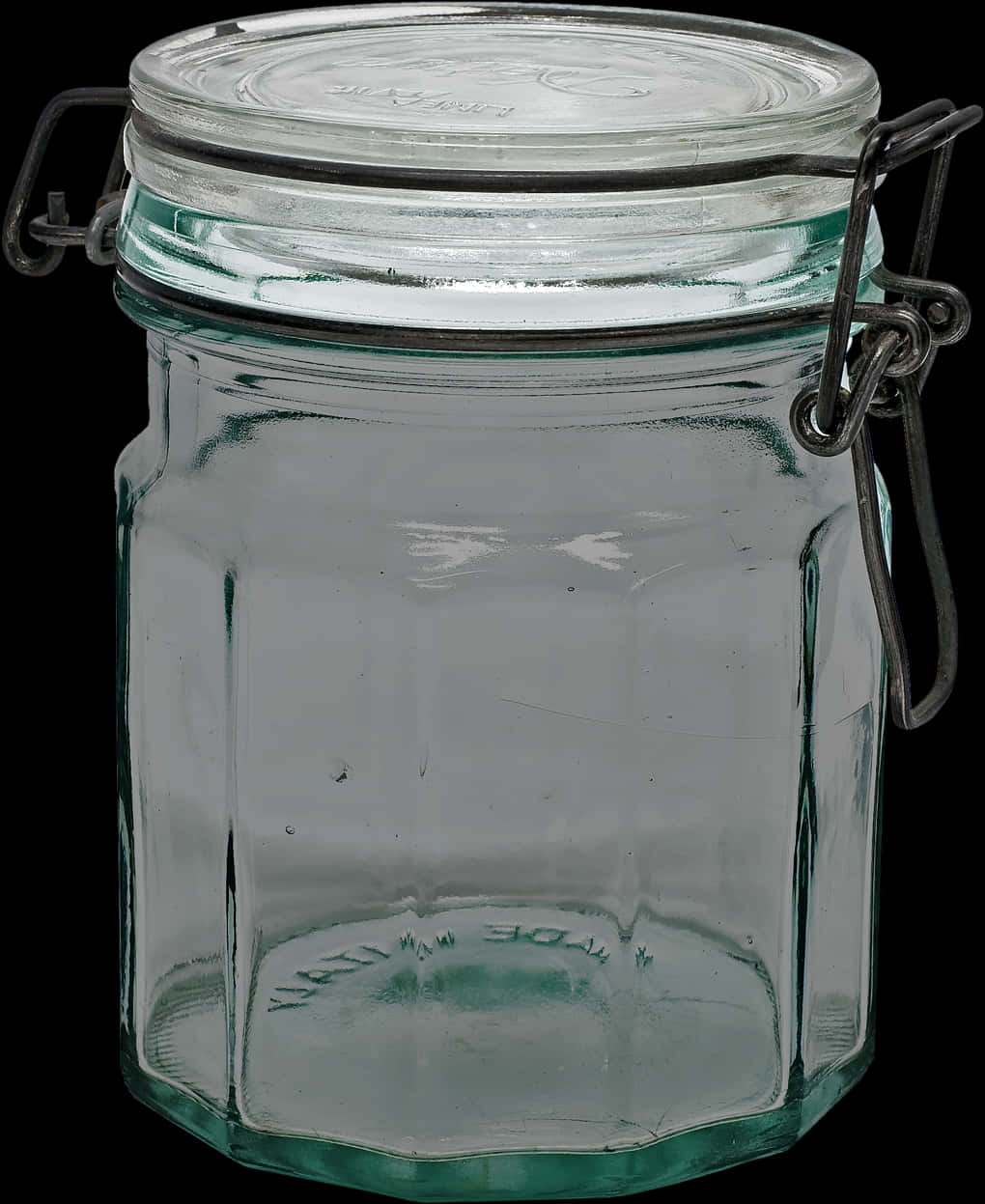 A Clear Glass Jar With A Metal Wire Lid