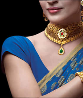 A Close-up Of A Woman Wearing A Gold Necklace