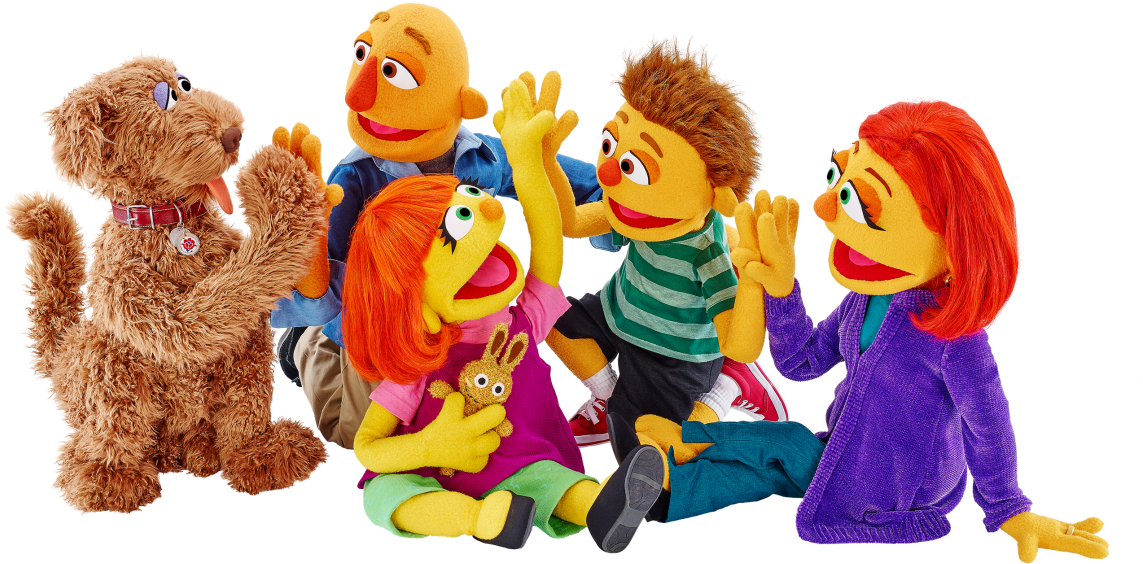 A Group Of Puppets With Their Hands Up