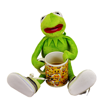 A Green Frog Doll Holding A Mug