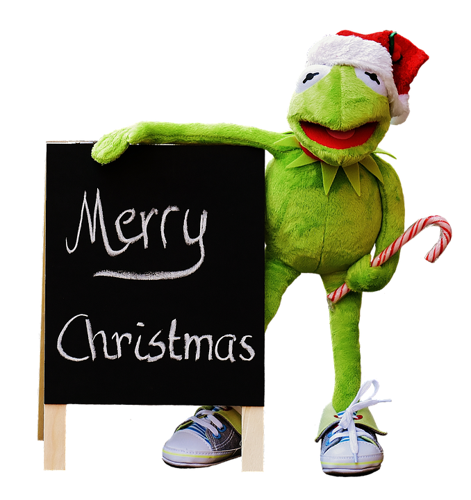 A Green Frog Doll With A Candy Cane And A Blackboard