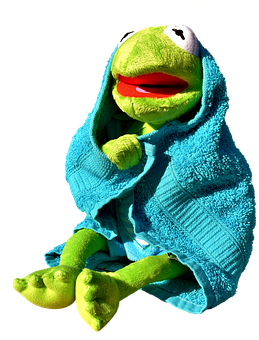 A Green Frog Puppet Wrapped In A Blue Towel