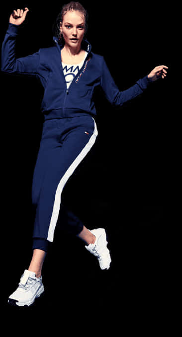 A Woman In A Blue Tracksuit Jumping