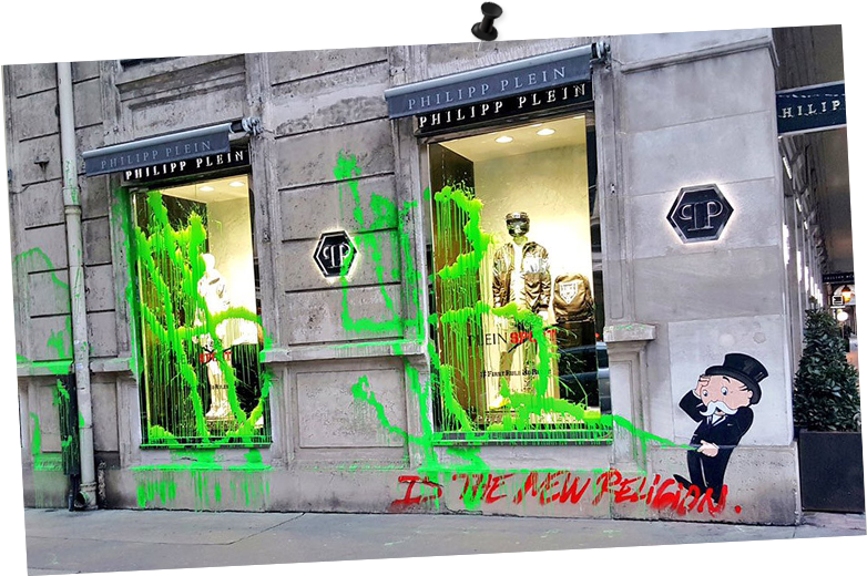 A Store Front With Green Paint Splattered On The Windows