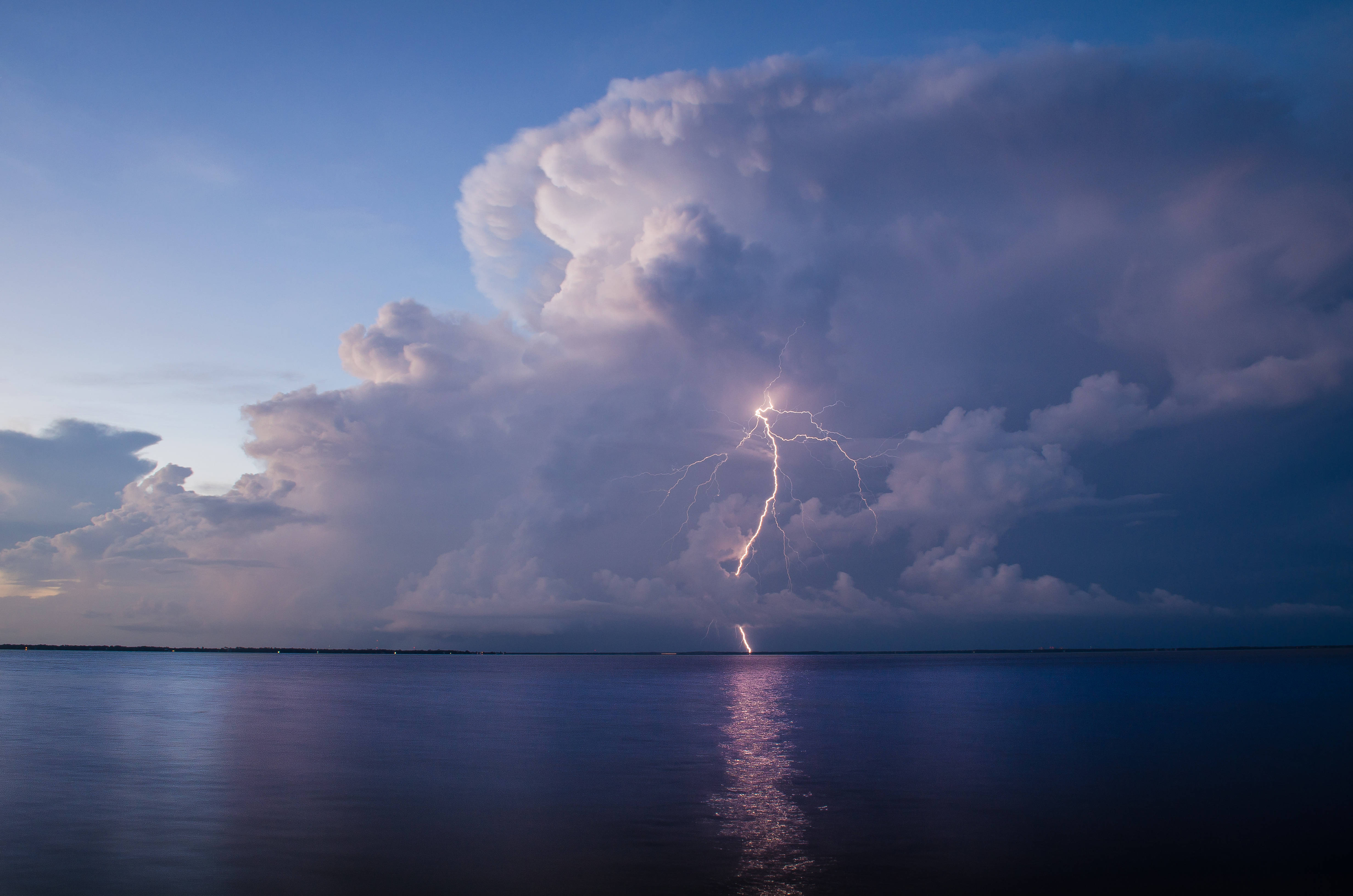Lightning Striking A Cloud Over Water