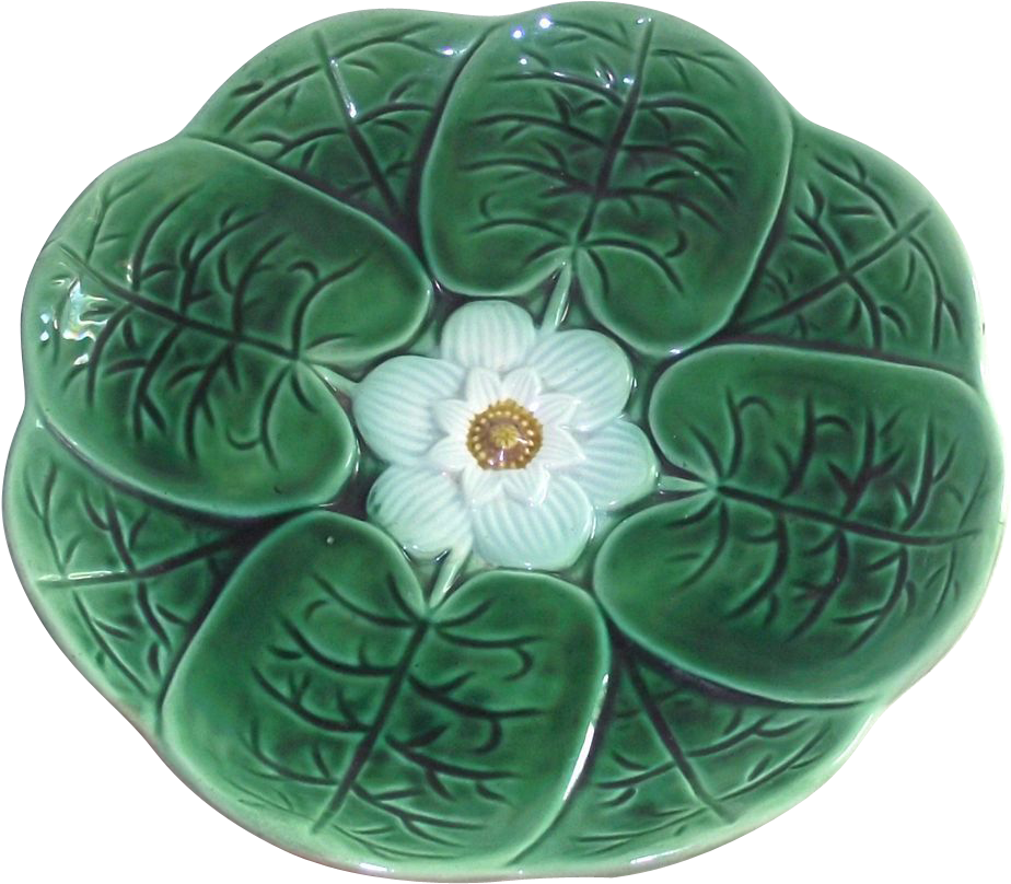 A Green Plate With A White Flower In The Center