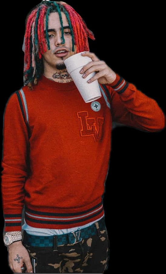 A Man With Dreadlocks Drinking From A Cup