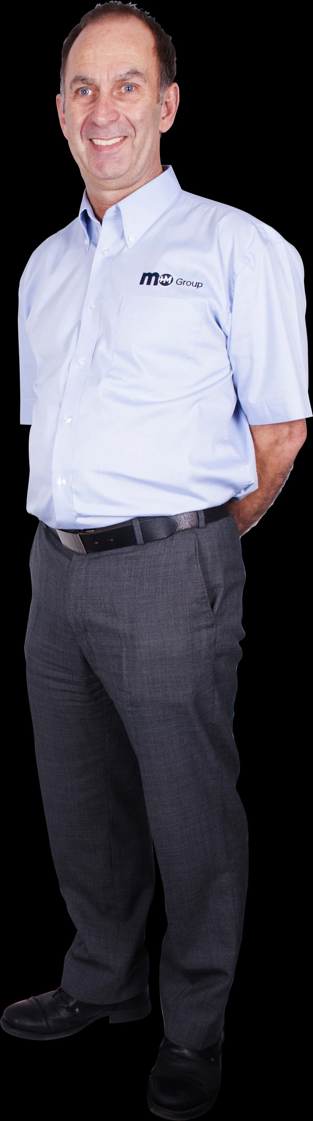 A Man In A Blue Shirt And Grey Pants