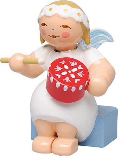 A Small Ceramic Figurine Of A Angel Playing A Drum
