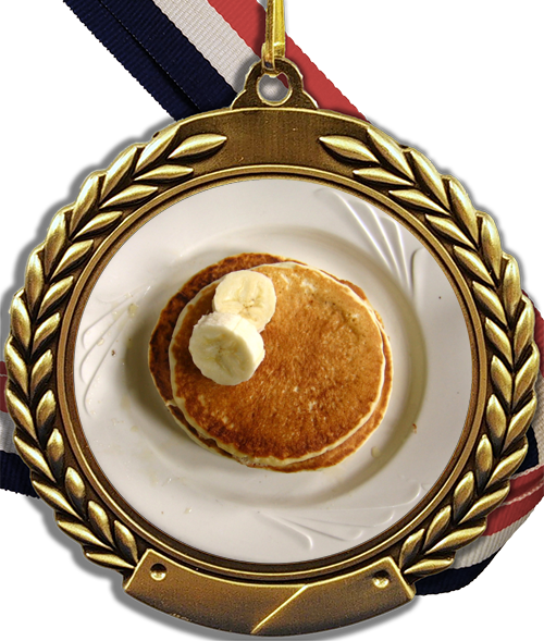 A Gold Medal With A Stack Of Pancakes And Bananas On It