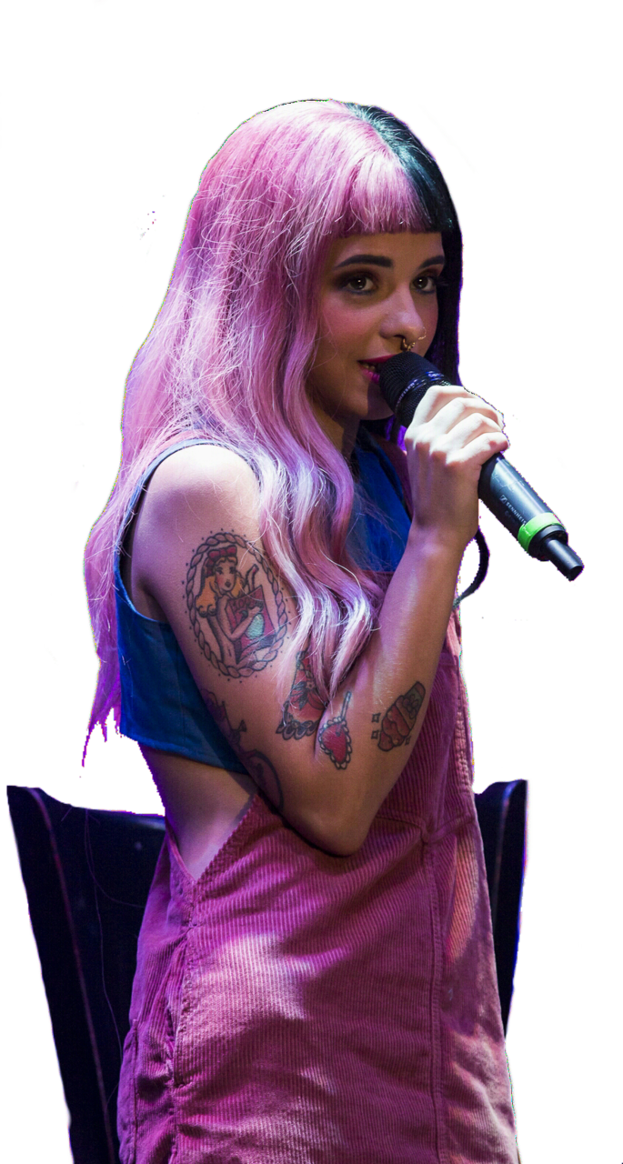 A Woman With Pink Hair Holding A Microphone