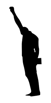 A Silhouette Of A Man Holding His Hand Up