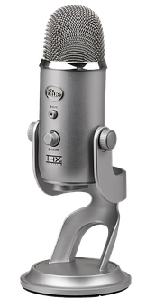 A Silver Microphone With Buttons And A Black Background