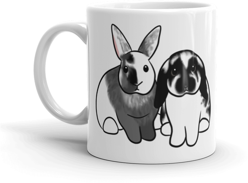 A White Mug With Rabbits On It