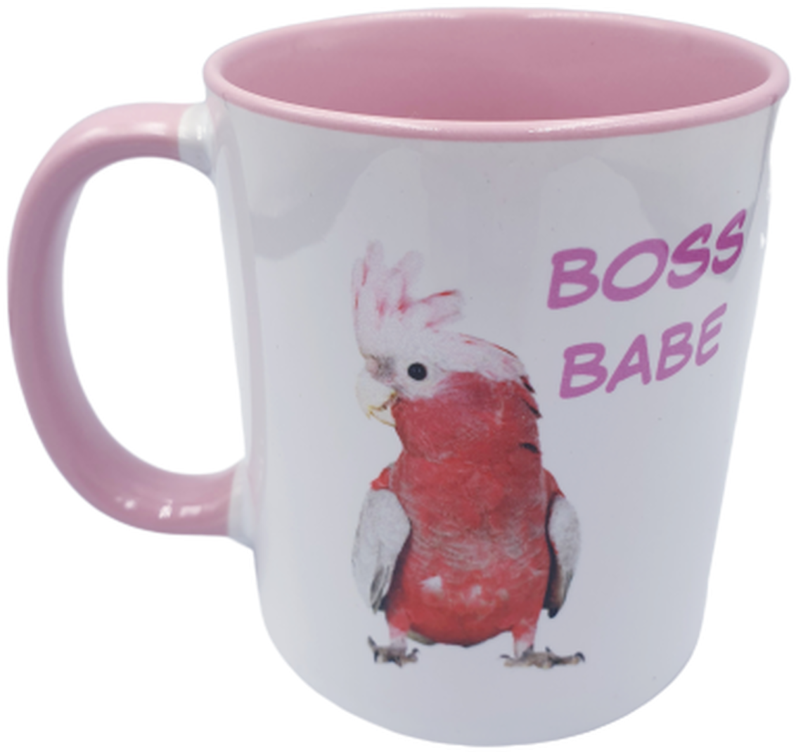 A White And Pink Mug With A Bird On It