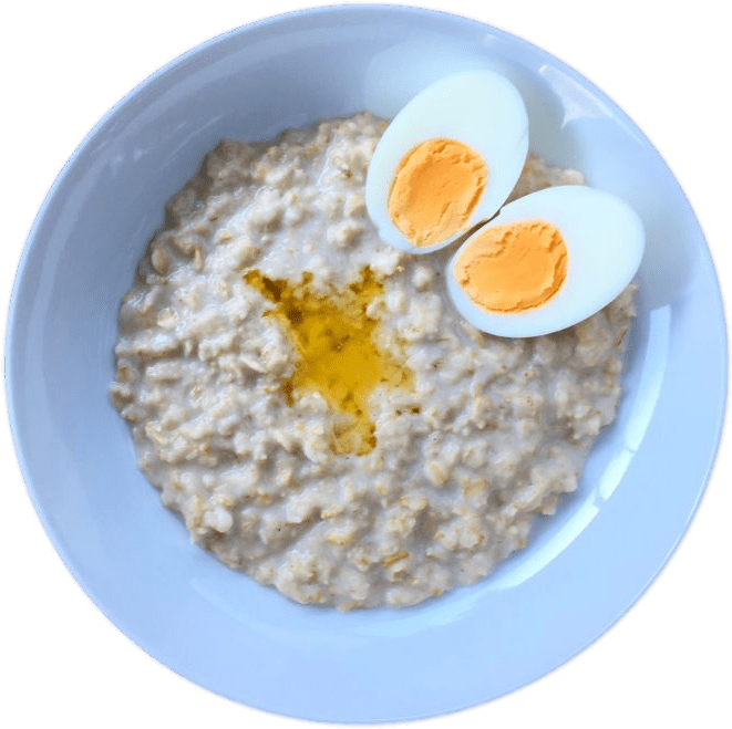 A Bowl Of Oatmeal With Boiled Eggs
