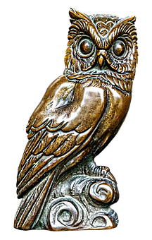 A Bronze Owl Statue On A Black Background