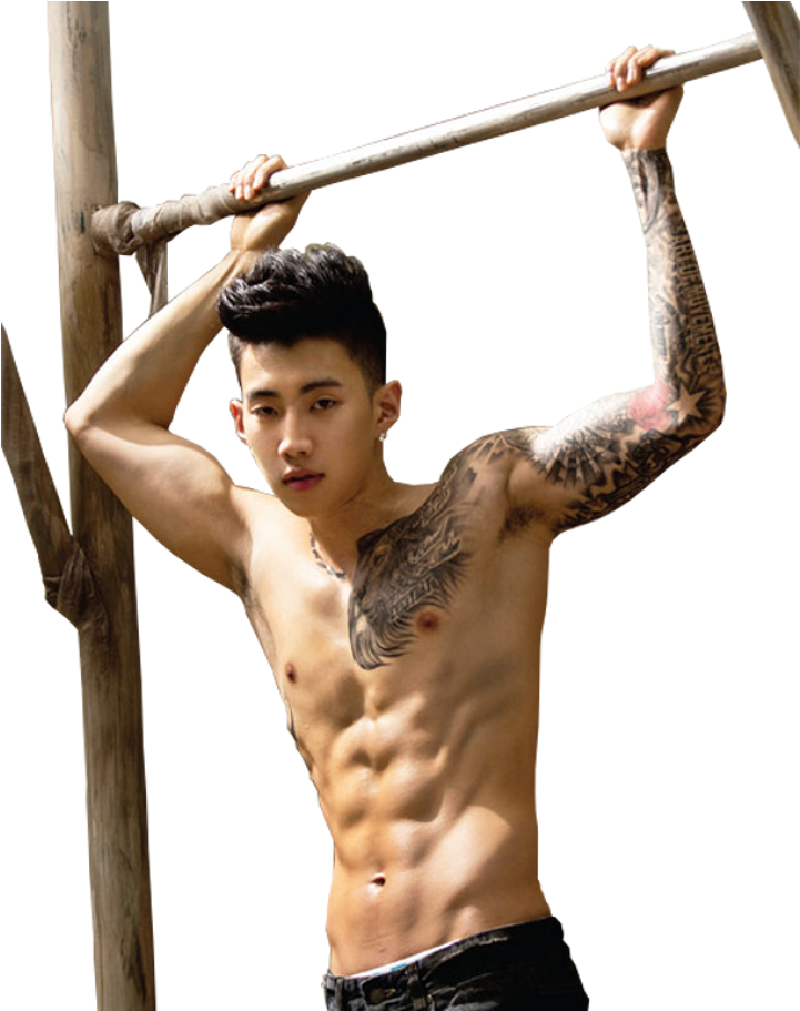 A Man With Tattoos On His Arm And A Wooden Bar