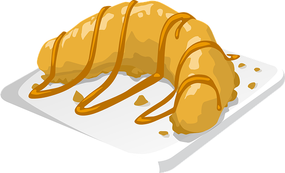 A Croissant With Caramel Sauce On A White Plate