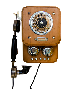 A Wooden Telephone With A Black Background