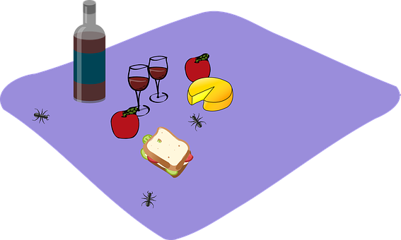 A Table With Food And A Bottle Of Wine