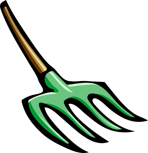 A Green Pitchfork With A Wooden Handle