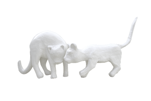 A White Statue Of A Cat And A Lion