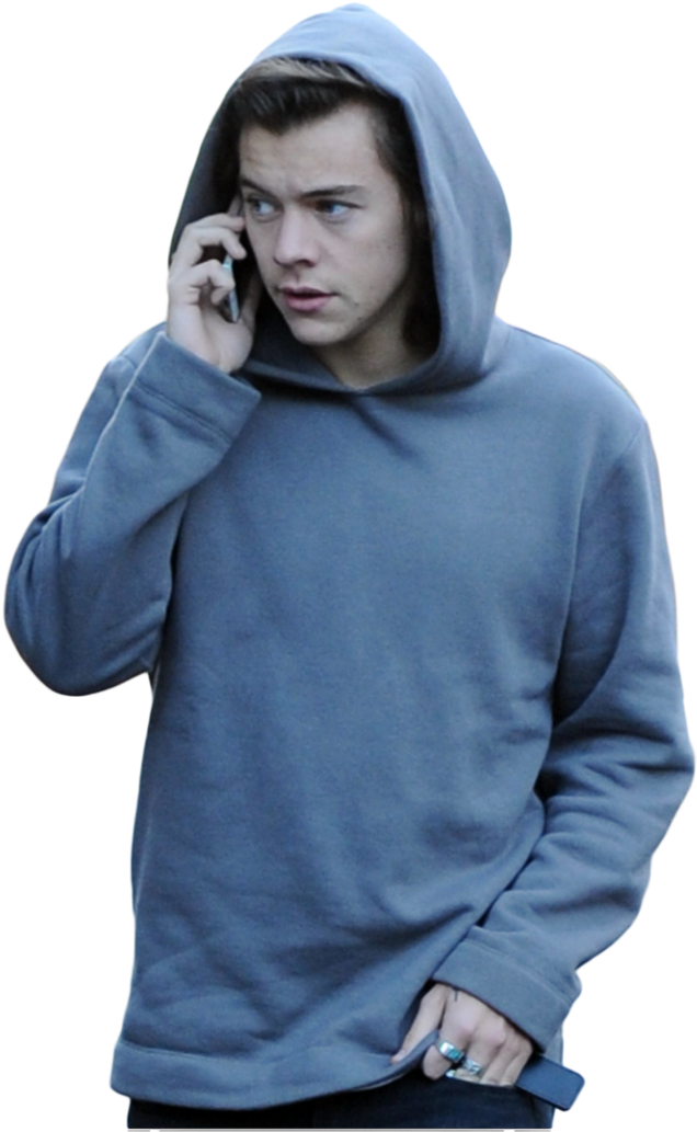 A Man In A Hoodie Talking On A Cell Phone