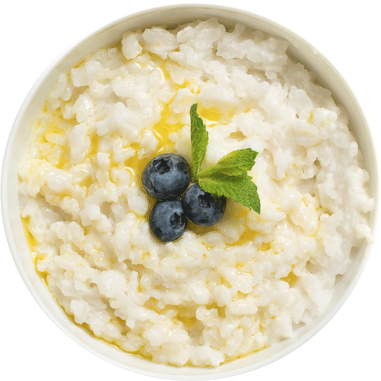 A Bowl Of Rice Pudding With Blueberries And Mint Leaves