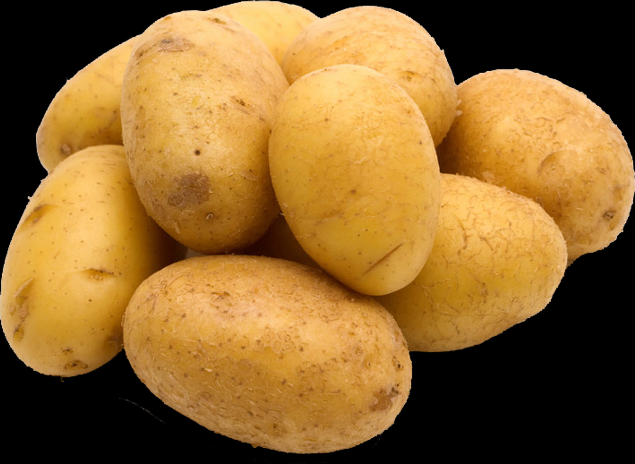 A Pile Of Potatoes On A Black Background