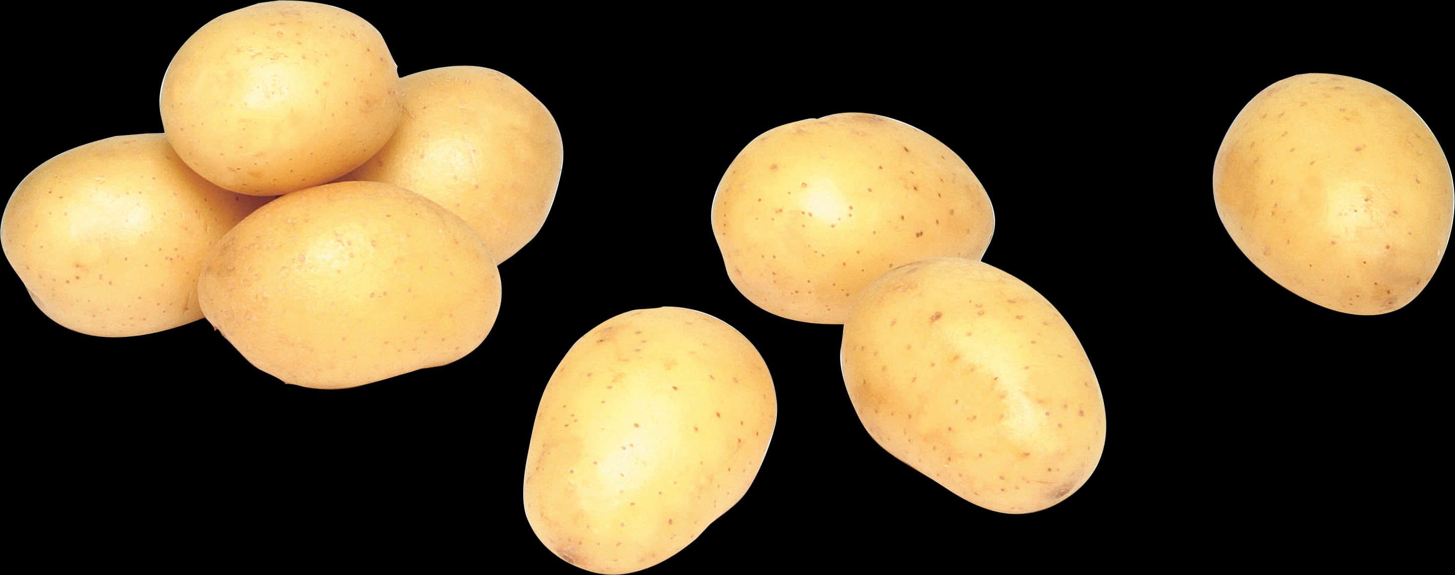 A Group Of Potatoes On A Black Background