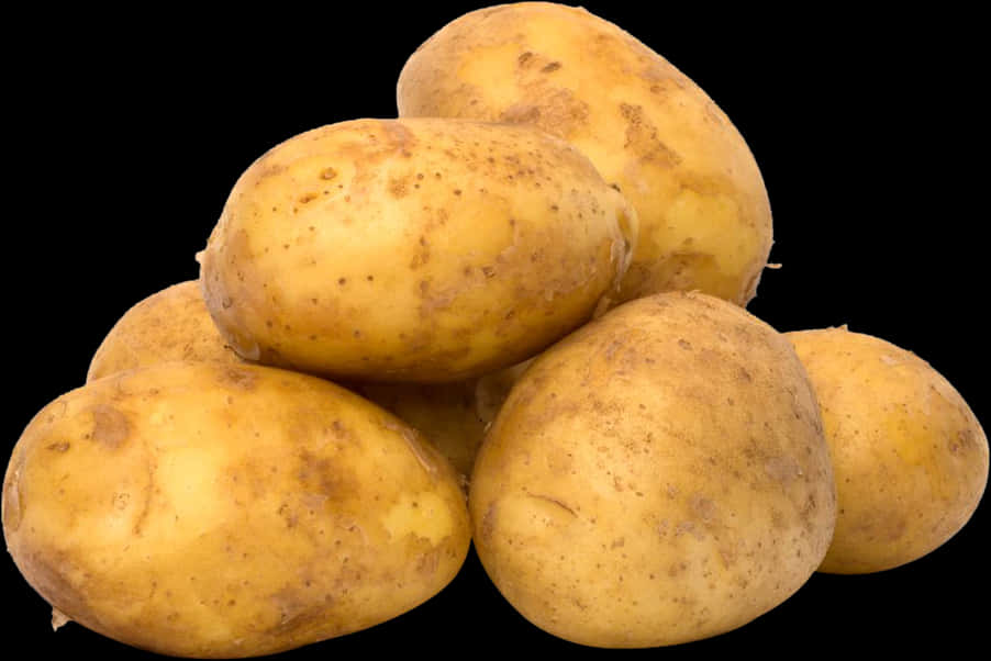A Pile Of Potatoes On A Black Background