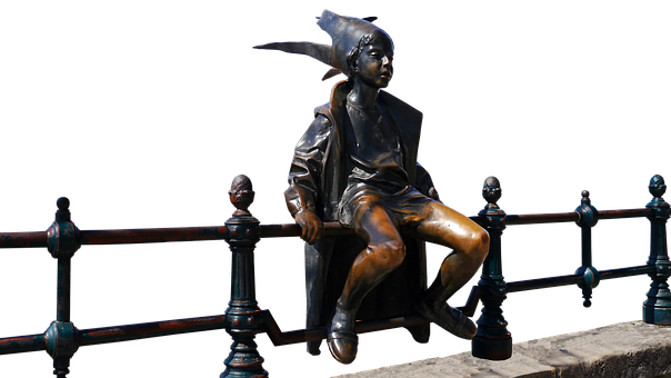 A Statue Of A Boy Sitting On A Railing
