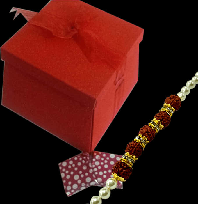 A Red Box With A Bracelet And A Red Box With A Bow