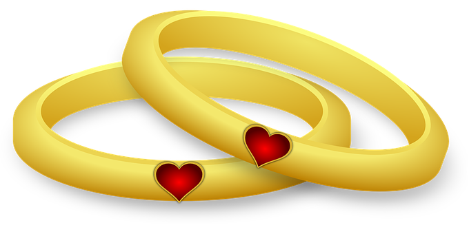 A Couple Of Gold Rings With Red Hearts