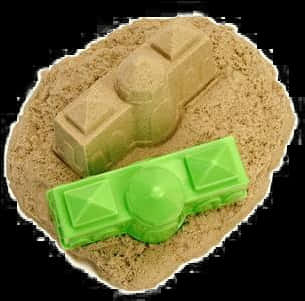 A Sand Castle With A Green Object On It