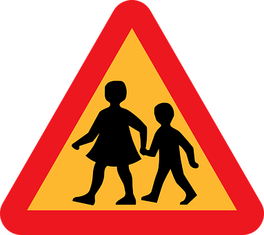 A Yellow And Red Sign With Silhouettes Of Children Walking