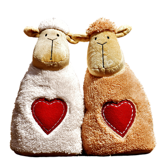 Two Stuffed Animals With Hearts On Them