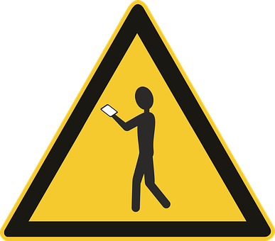 A Yellow Triangle Sign With A Person Holding A Cell Phone