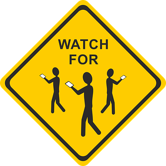 A Yellow Sign With Black Text And Figures Of People Holding Phones