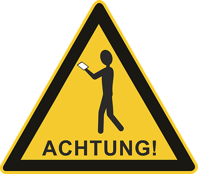 A Yellow Triangle Sign With A Person Holding A Phone