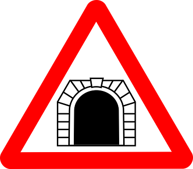 A Red And White Triangle Sign With A Tunnel In The Middle