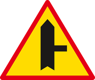 A Yellow Triangle With A Black Arrow On It