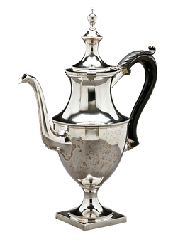 A Silver Tea Pot With A Black Background
