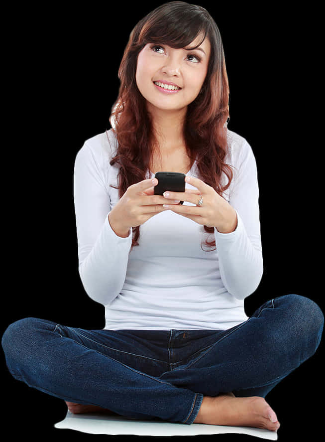 A Woman Sitting Cross Legged With Legs Crossed And Holding A Phone