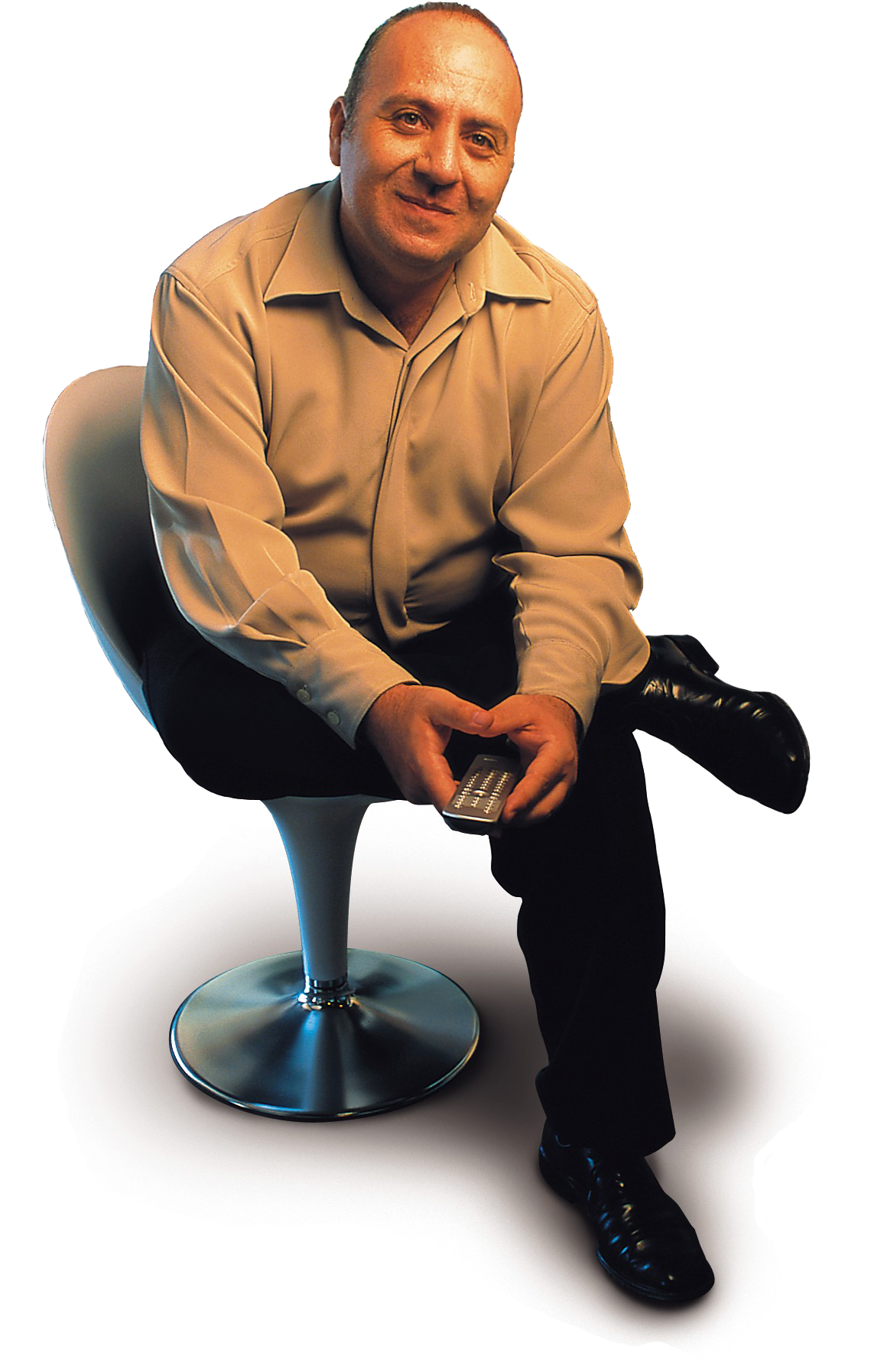 A Man Sitting In A Chair Holding A Remote
