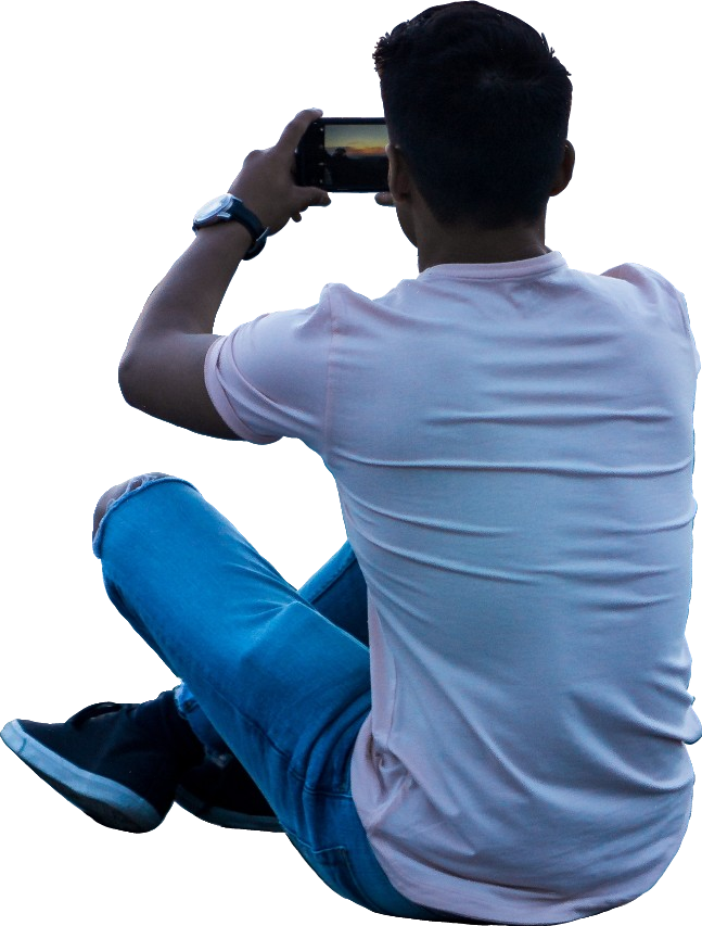 A Man Sitting Down Taking A Picture Of Himself